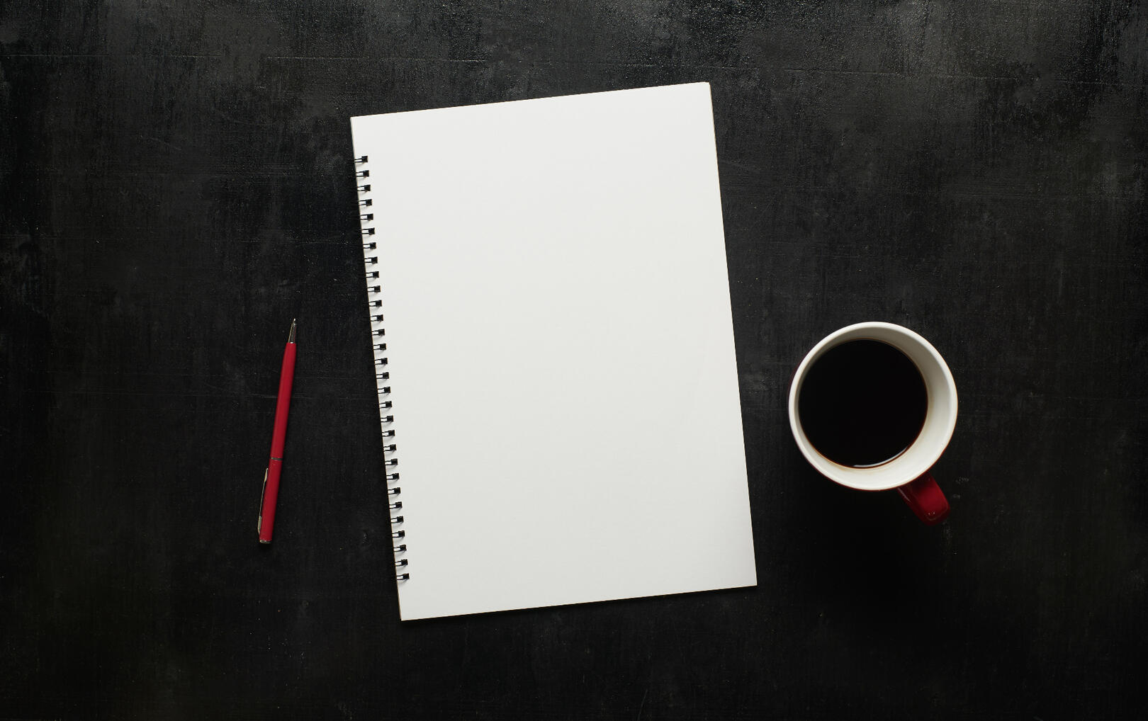 Notebook on desk with coffee